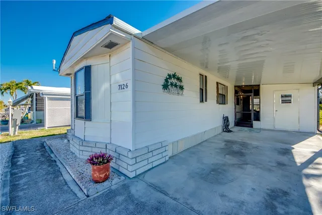 a view of an empty room with a windows and potted plants