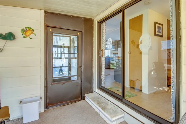 a utility room with cabinets and wooden floor