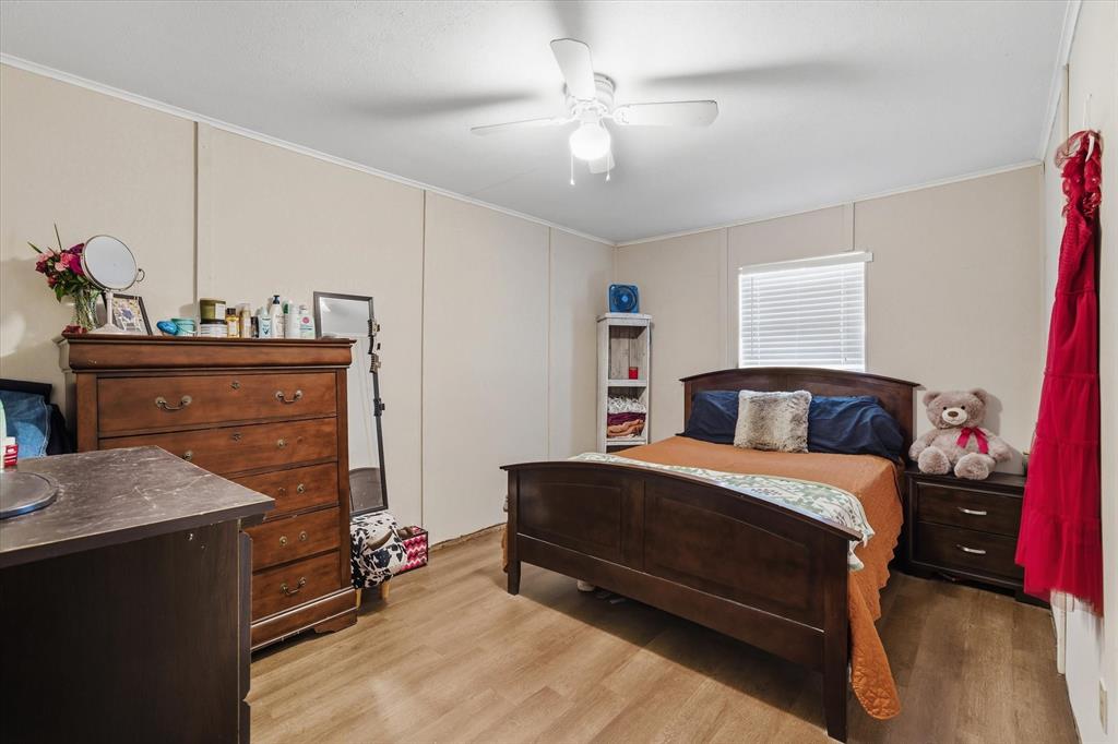 700 Amy Street Canton, TX 75103 - Photo 12 of 35 a bedroom with a bed and a chandelier