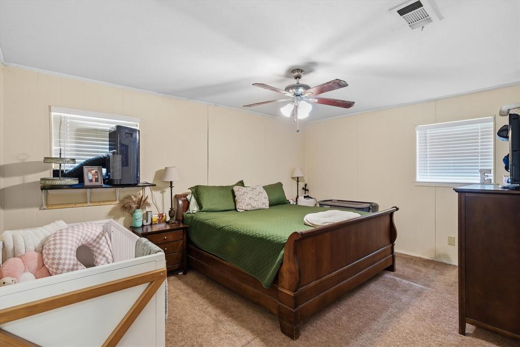 700 Amy Street Canton, TX 75103 - Photo 18 of 35 a bedroom with a bed a couch and dresser