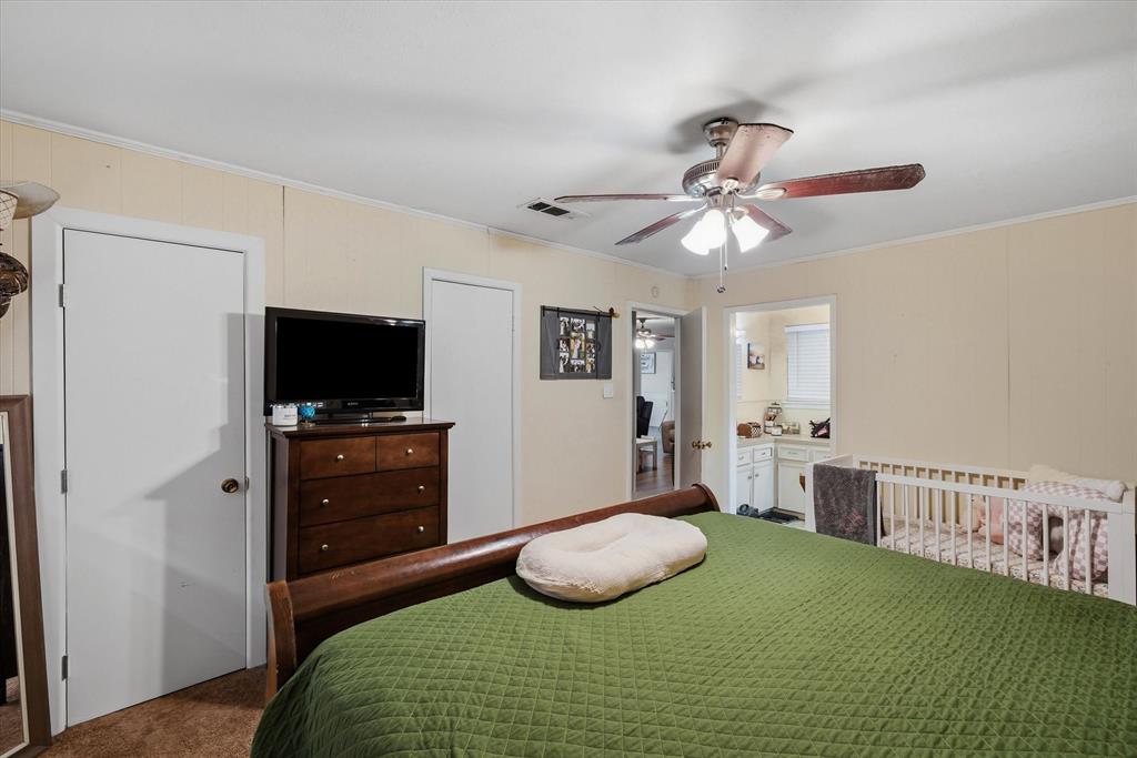 700 Amy Street Canton, TX 75103 - Photo 19 of 35 a bedroom with a bed and a flat screen tv