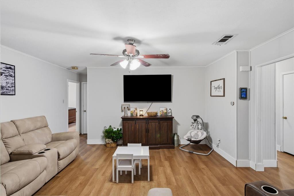 700 Amy Street Canton, TX 75103 - Photo 22 of 35 a living room with furniture a flat screen tv and a view of kitchen