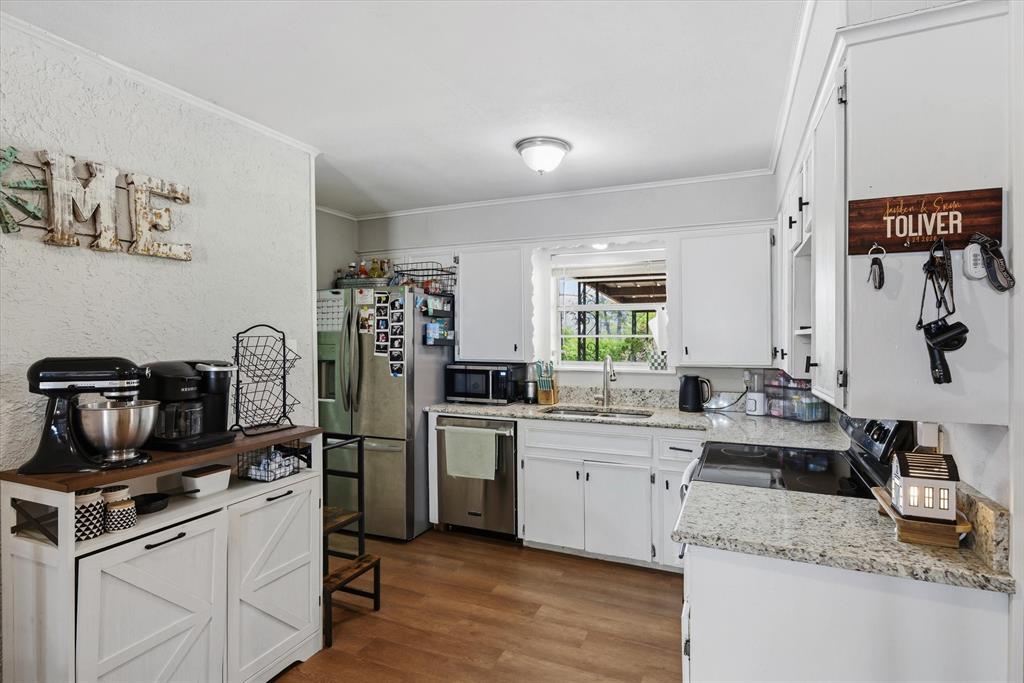 700 Amy Street Canton, TX 75103 - Photo 24 of 35 a kitchen with a sink cabinets and appliances