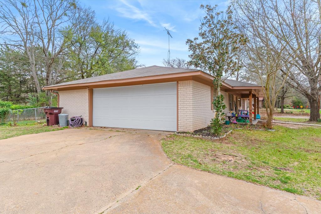 700 Amy Street Canton, TX 75103 - Photo 5 of 35 a view of a house with a yard and large tree