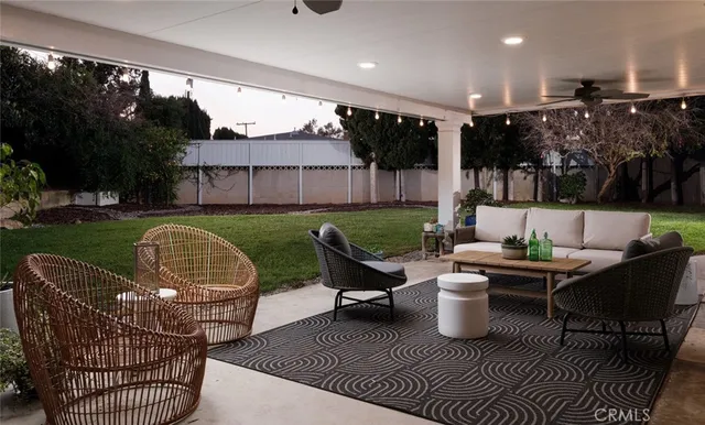 a patio with patio couch and outdoor seating