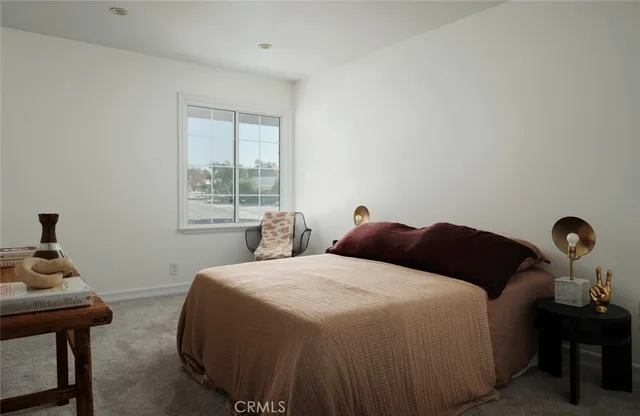 a bedroom with a bed and with a window