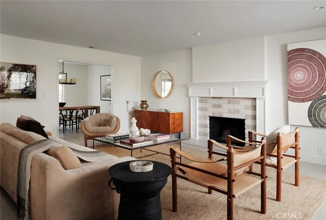 a living room with furniture a fireplace and a table