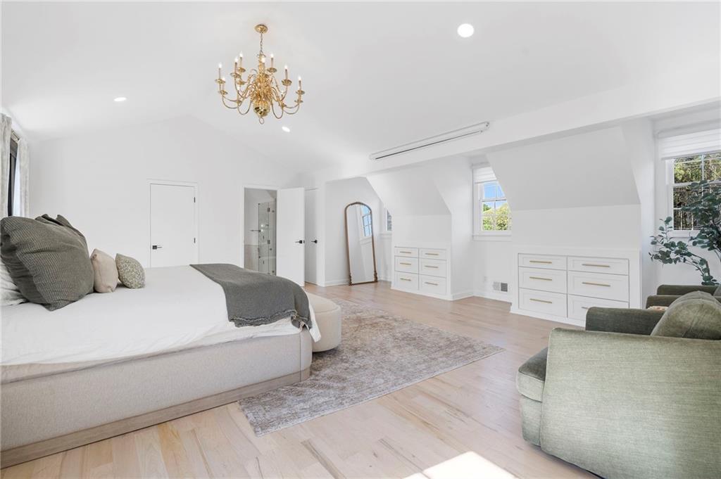 403 Rockbridge Road Southwest Lilburn, GA 30047 - Photo 37 of 77 a bedroom with a bed and a chandelier