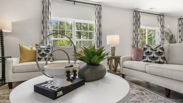 a living room with furniture and a large window