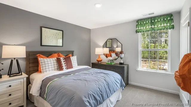 a bedroom with a bed and a window