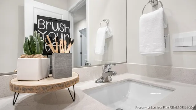 a bathroom with a tub sink and mirror