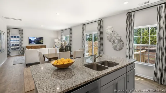 a kitchen with a sink a stove and chairs