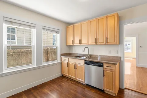 a kitchen with a refrigerator and a stove top oven