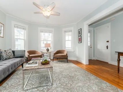 a living room with furniture and a chandelier