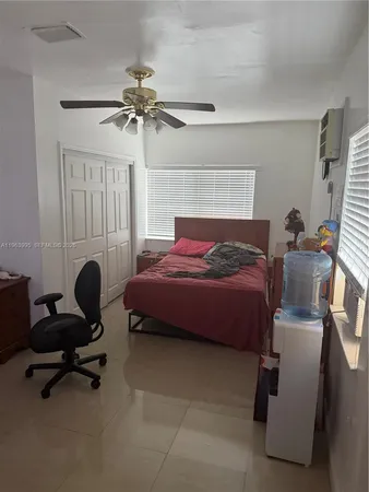 a bedroom with a bed and a chair