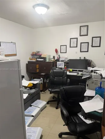 a work room with furniture and a window