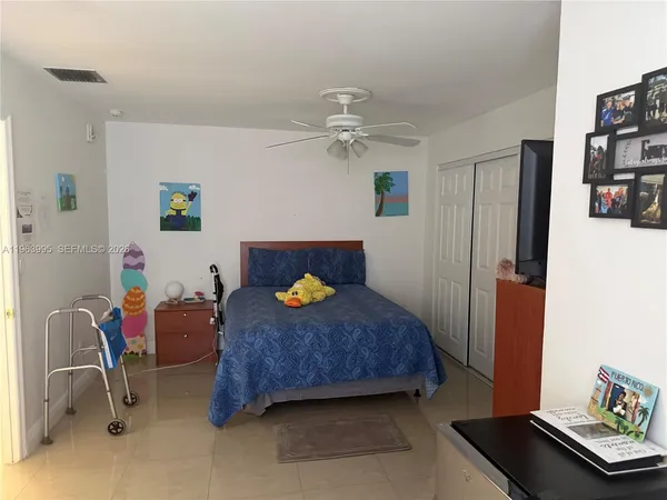 a bedroom with a bed and a book shelf