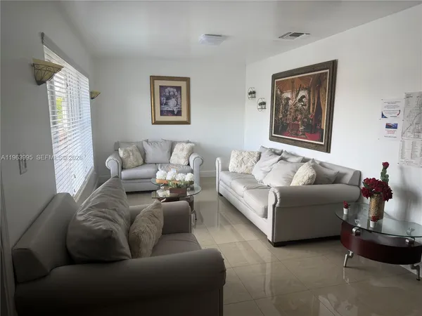 a living room with furniture and a window