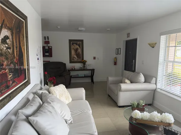 a living room with furniture and a large window