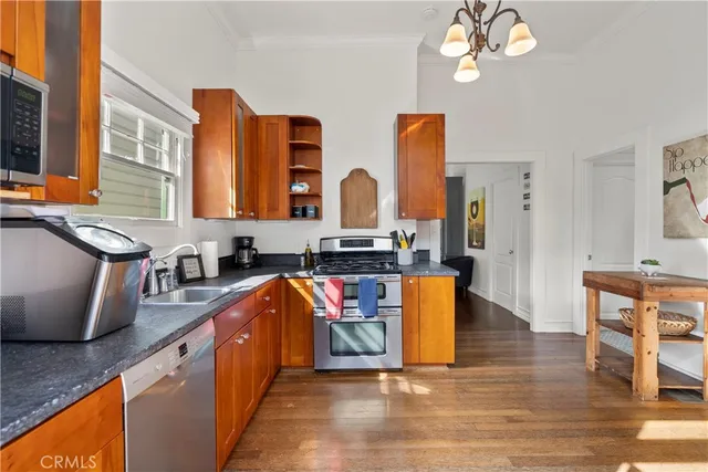 a kitchen with stainless steel appliances granite countertop a granite counter tops and a view of living room