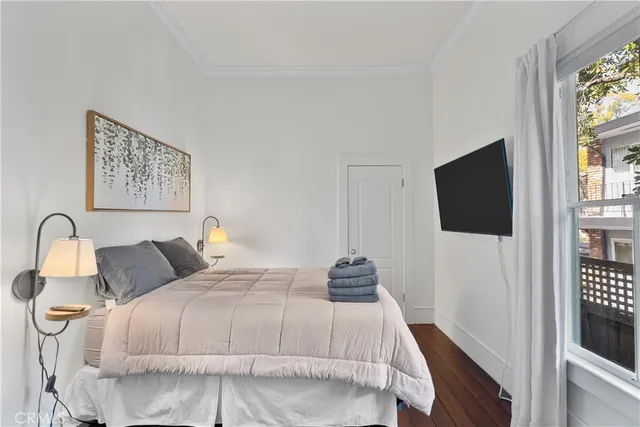 a bedroom with a bed and a flat screen tv