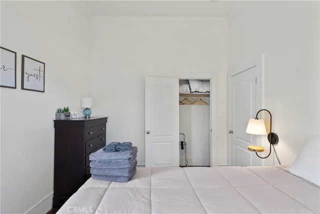 a bedroom with a bed and a chandelier