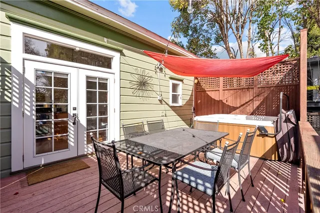 a view of a patio with table and chairs with wooden floor and fence