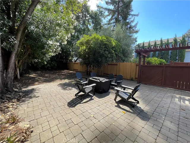 a view of a backyard with a tree