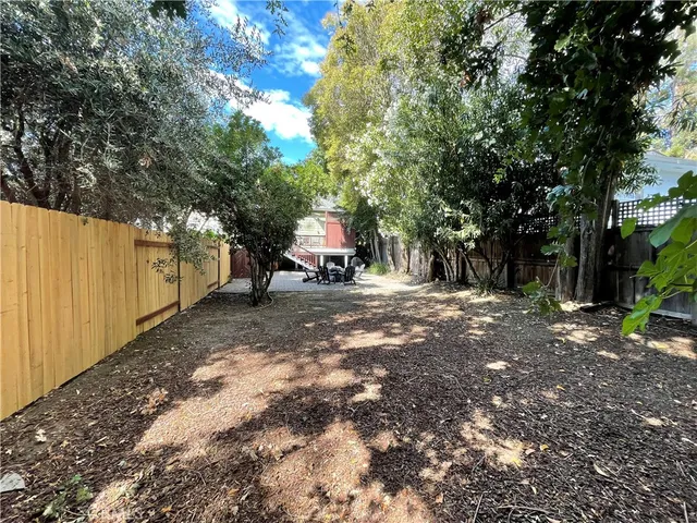 a view of a tree in the middle of a yard
