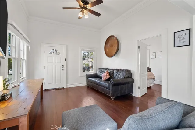 a living room with couches a fireplace and a flat screen tv
