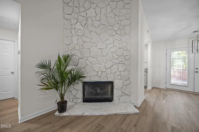 wooden floor in an empty room with a fireplace