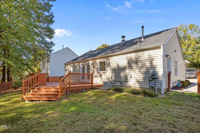 a backyard of a house with table and chairs