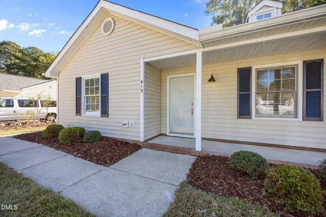 a view of a house with pool and chairs