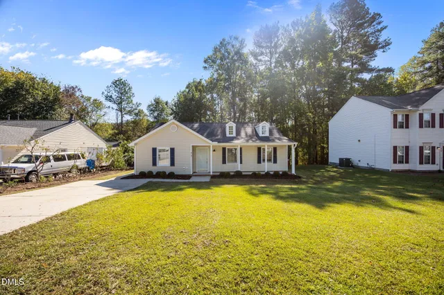 a view of a house with yard and swimming pool