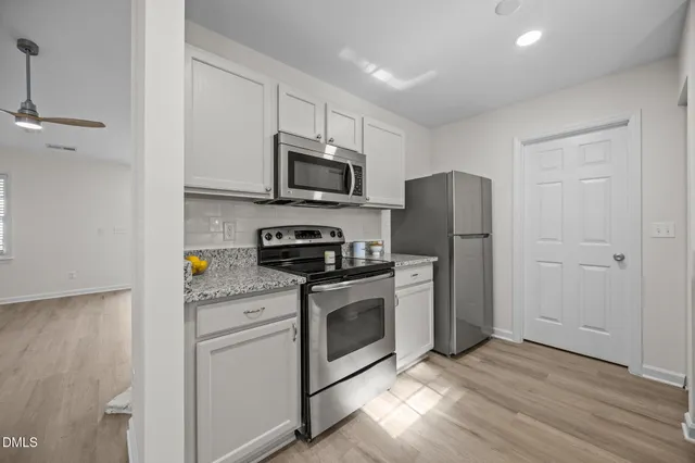 a kitchen with stainless steel appliances a refrigerator stove and microwave