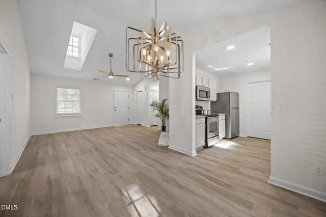 a view of a kitchen with wooden floor and a window