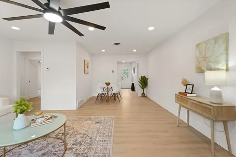a living room with furniture and a dining table