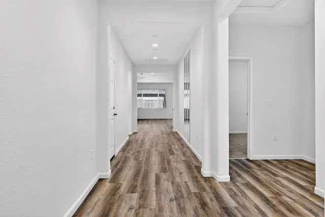 a view of hallway with wooden floor