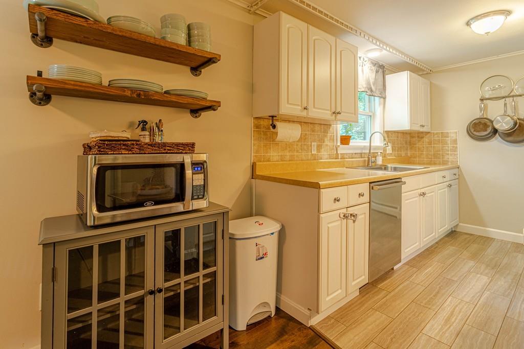 9 Holden Road Shirley, MA 01464 - Photo 16 of 42 a kitchen with a sink a stove and cabinets