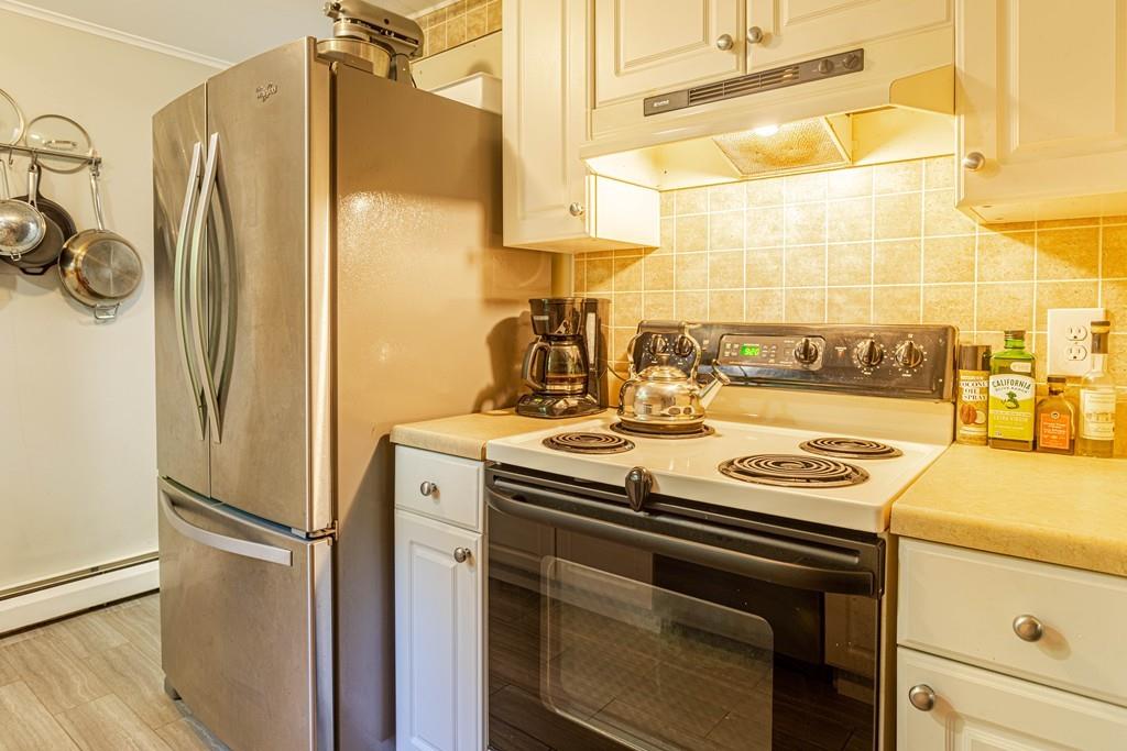 9 Holden Road Shirley, MA 01464 - Photo 19 of 42 a kitchen with a stove and a refrigerator
