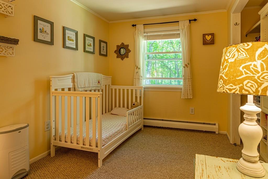 9 Holden Road Shirley, MA 01464 - Photo 27 of 42 a view of a bedroom with wooden floor and furniture
