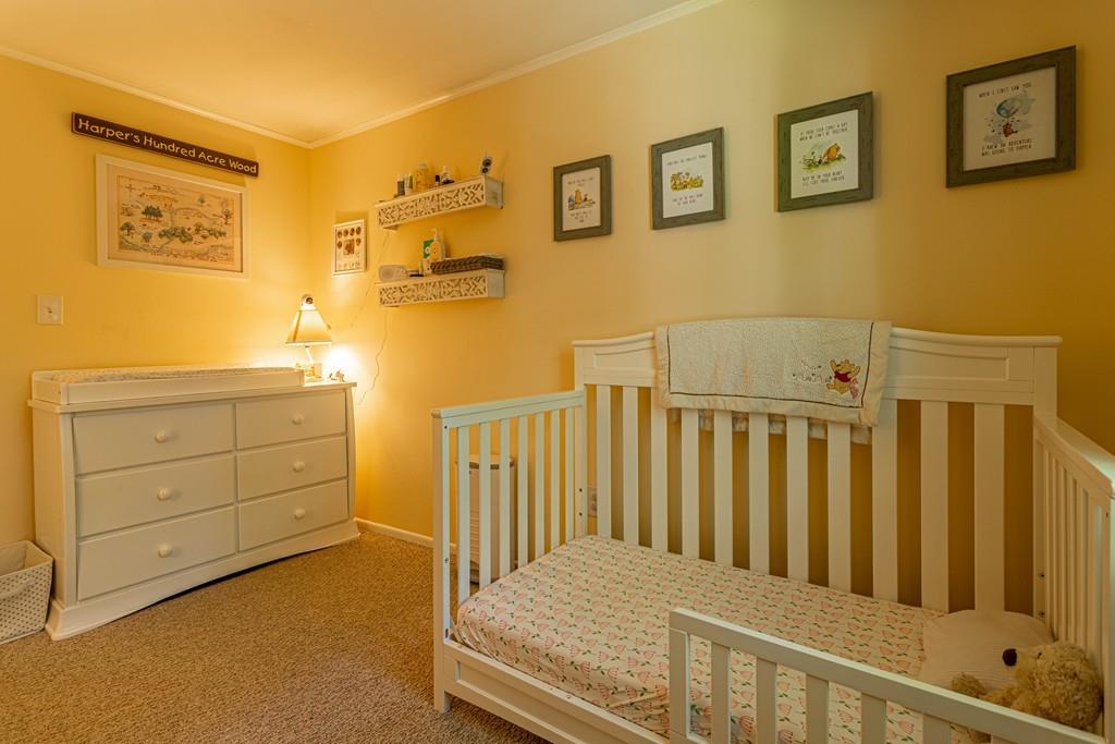 9 Holden Road Shirley, MA 01464 - Photo 28 of 42 a bedroom with a bed and paintings on the wall