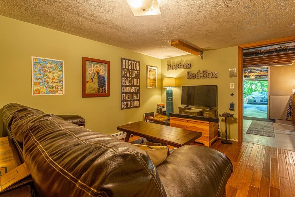 9 Holden Road Shirley, MA 01464 - Photo 32 of 42 a view of a livingroom with furniture and a flat screen tv