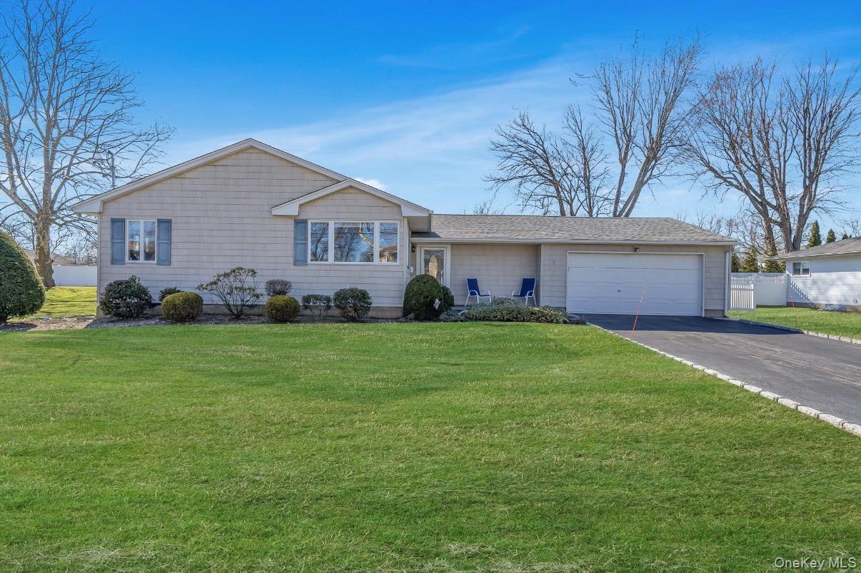 a front view of house with yard and green space