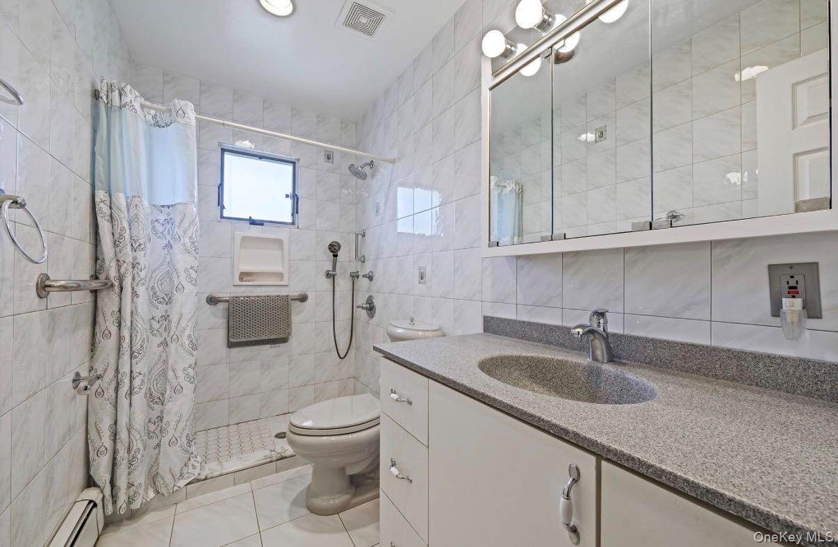 8 Leeward Lane Commack, NY 11725 - Photo 11 of 17 a bathroom with a sink toilet and shower