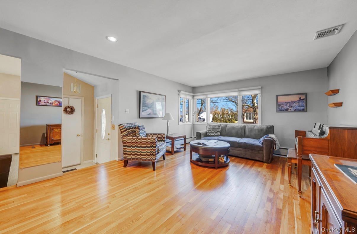 8 Leeward Lane Commack, NY 11725 - Photo 2 of 17 a living room with furniture and wooden floor