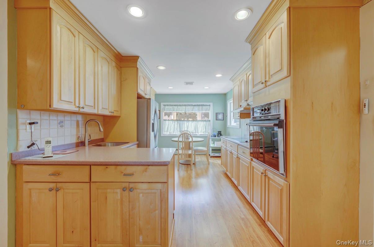 8 Leeward Lane Commack, NY 11725 - Photo 4 of 17 a kitchen with a sink stove and cabinets