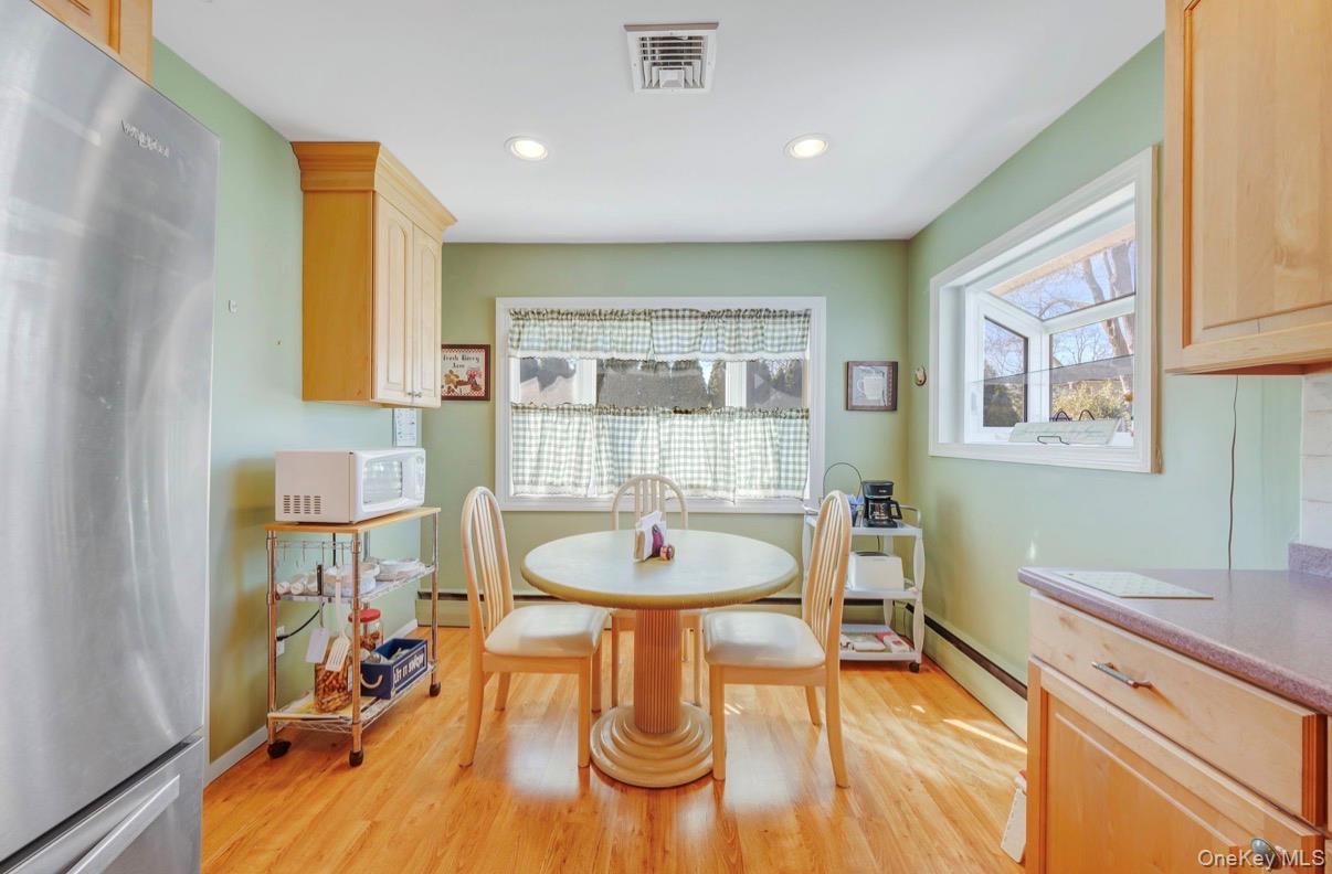 8 Leeward Lane Commack, NY 11725 - Photo 5 of 17 a view of a dining room with furniture and a wooden floor
