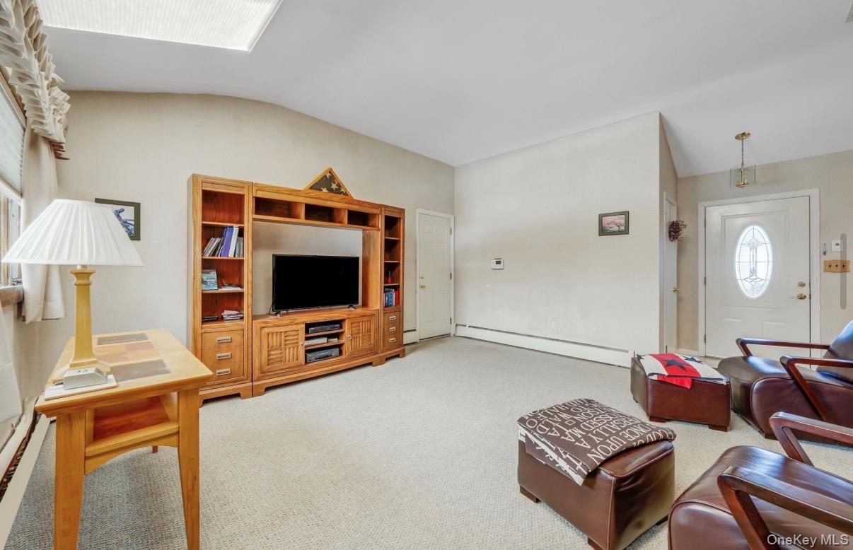 8 Leeward Lane Commack, NY 11725 - Photo 6 of 17 a living room with furniture and a flat screen tv