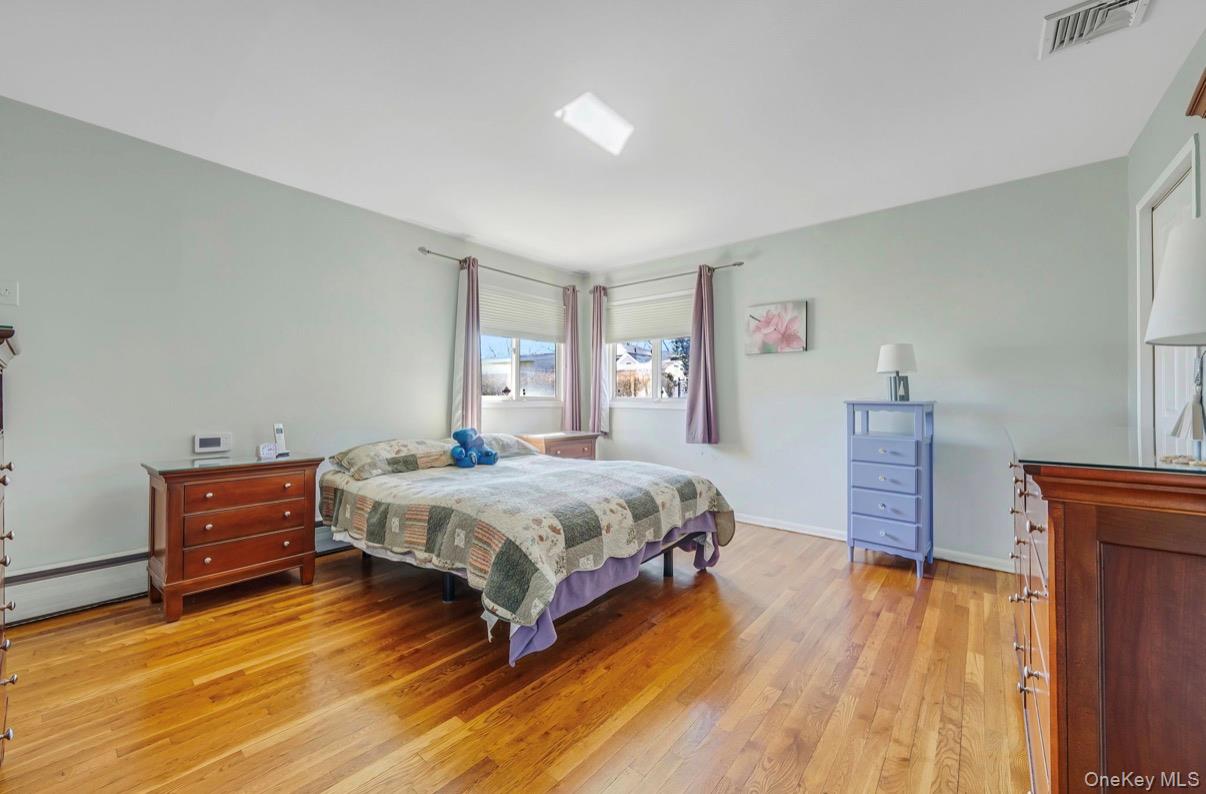 8 Leeward Lane Commack, NY 11725 - Photo 8 of 17 a bedroom with a bed and a desk